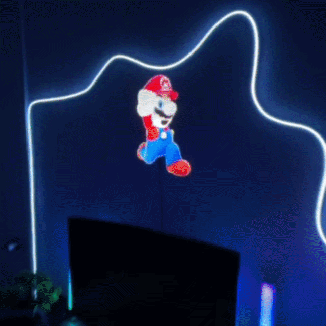 Neon light shaped like a character from a video game on a dark background